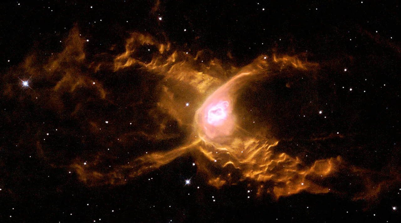 Hubble image of the Red Spider Nebula NGC 6537, showing two-lobed structure with wave-like patterns sculpted by stellar winds
