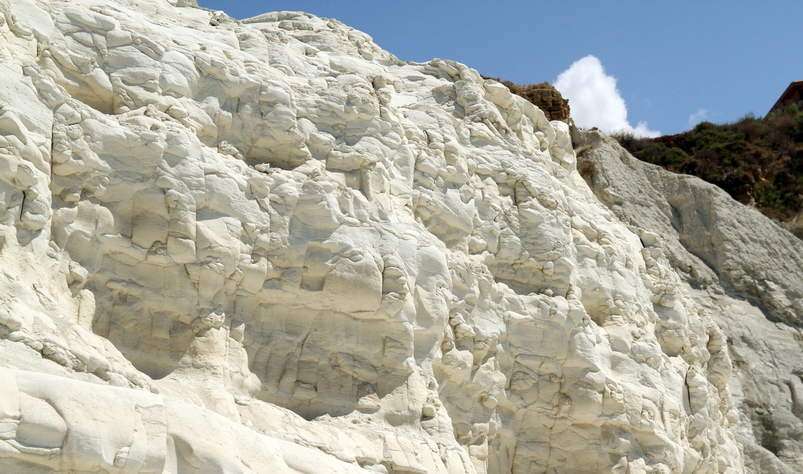 White limestone strata at Scala dei Turchi in Sicily, layers laid down over millions of years and now exposed in cross-section by the sea